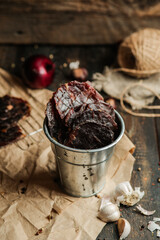 Homemade beef jerky seasoned with garlic, onion, pepper and salt. Jerky in a bucket on a wooden...