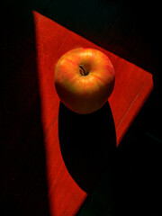 ripe apple on a red table