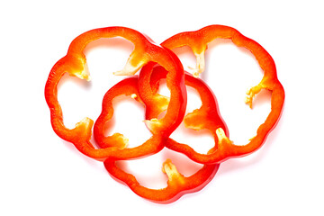 Heart shaped sweet red pepper slices on white, isolated, healthy eating concept.