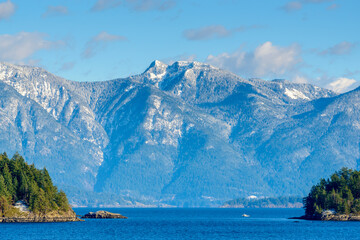 Fantastic view over ocean, snow mountain and rocks at Sechelt inlet in Vancouver, Canada.