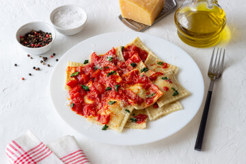 Ravioli with tomato sauce, spinach and parmesan cheese. Healthy eating. Vegetarian food. Italian cuisine.