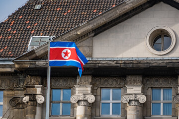 Naklejka premium north korean flag in front of old building in berlin