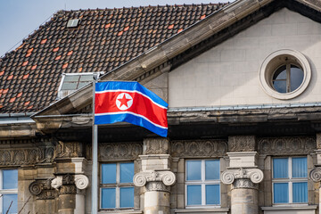 north korean flag waving in front of old building in berlin