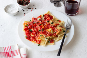 Ravioli with tomato sauce, spinach and parmesan cheese. Healthy eating. Vegetarian food. Italian cuisine.