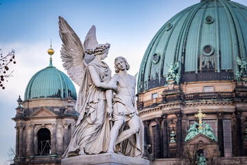 statue of angle and saint peter basilica with berlin dome