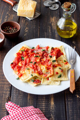 Ravioli with tomato sauce, spinach and parmesan cheese. Healthy eating. Vegetarian food. Italian cuisine.