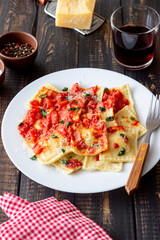 Ravioli with tomato sauce, spinach and parmesan cheese. Healthy eating. Vegetarian food. Italian cuisine.