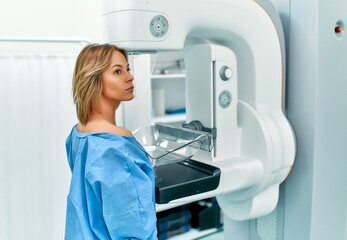 In the hospital, the patient undergoes a screening procedure for a mammogram, which is performed by...