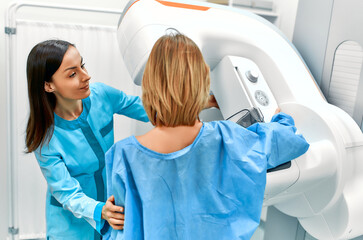 In the hospital, the patient undergoes a screening procedure for a mammogram, which is performed by...