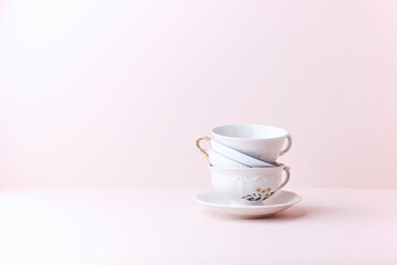 Stack of ceramic cups on bright background. Copy space. 