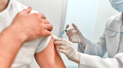 Vaccination, immunization campaign, disease prevention concept. Young man in medical face mask...