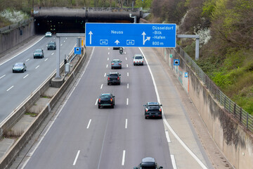 Empty German Autobahn in Dusseldorf with blue street signs and white arrows without traffic jam...