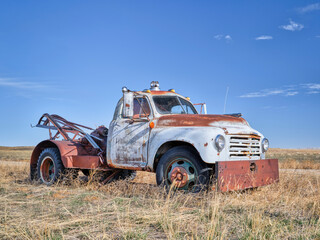 old rusty towing truck on a prairie, early spring scenery in Colorado