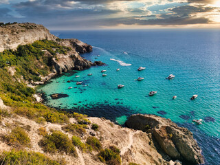 View of a beautiful bay with turquoise water and many boats at sunset