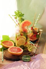 Refreshing drink of fruits, berries and citrus on the table, summer, homemade cocktails, healthy lifestyle