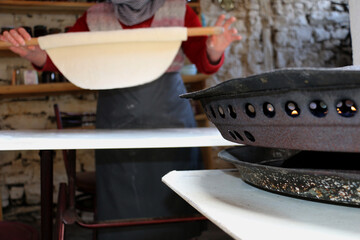 selected focus. A peasant woman organically cooks homemade pasta and dough for her family in the...