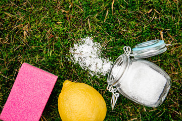 Citric acid in glass jar with lemon and cleaning sponge. Natural organic home cleaning products...
