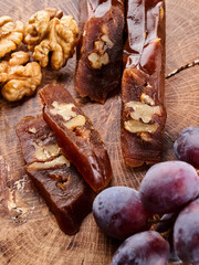 Churchkhela, national Georgian dessert made from grape juice and walnuts, composition on a wooden table