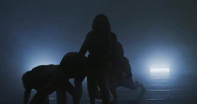 Silhouette of group dancers of contemporary ballet, ow key