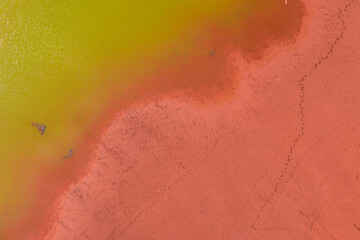 Neszmely, Hungary - Aerial view of drought red mud surface with green colored lake.