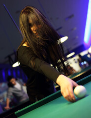 Young brunette girl playing snooker