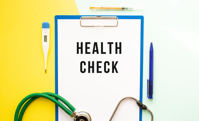 HEALTH CHECK text on a letterhead in a medical folder on a beautiful background.