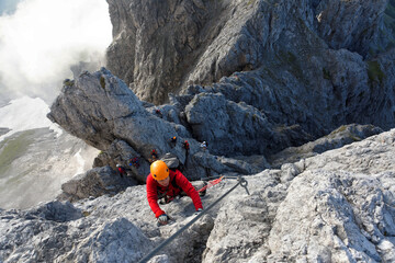 Climbing alpinist on Koenigsjodler route, Austria