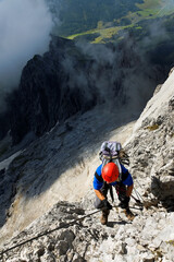 Climbing alpinist on Koenigsjodler route, Austria