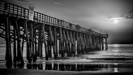 Black and white photo of the Flagler Beach Pier on the Atlantic Ocean coast of Florida. © Brett Ossman