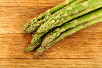 Fresh green asparagus on wooden board