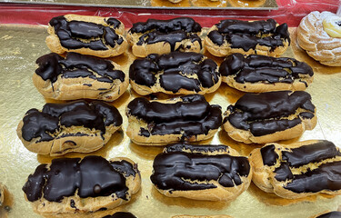Tray of large chocolate cream puffs