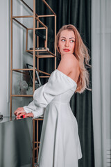 beautiful girl in a white dress in a photo studio