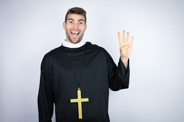 Young hispanic man wearing priest uniform standing over white background showing and pointing up...