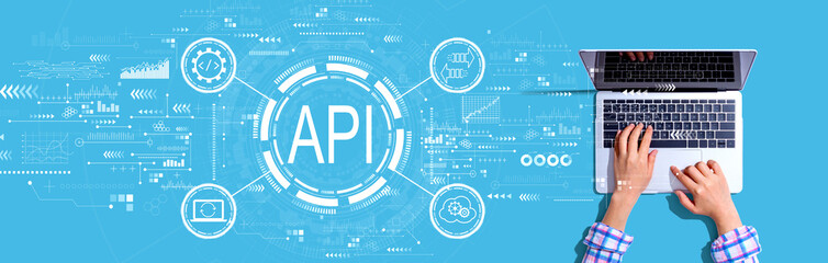 Obraz na płótnie Canvas API - application programming interface concept with person using a laptop
