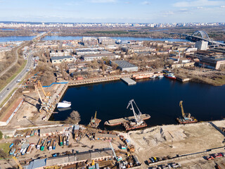 Aerial view of moored old barges and ships in river port