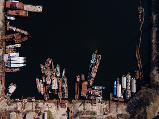Aerial view of moored old barges and ships in river port