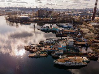 Aerial view of moored old barges and ships in river port