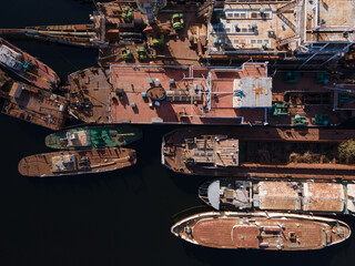 Aerial view of moored old barges and ships in river port