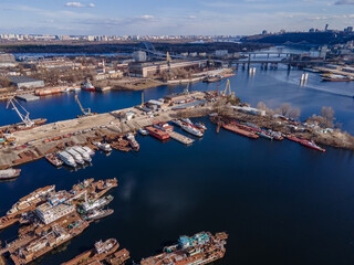 Aerial view of moored old barges and ships in river port