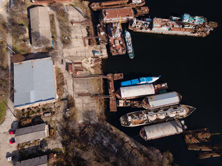 Aerial view of moored old barges and ships in river port