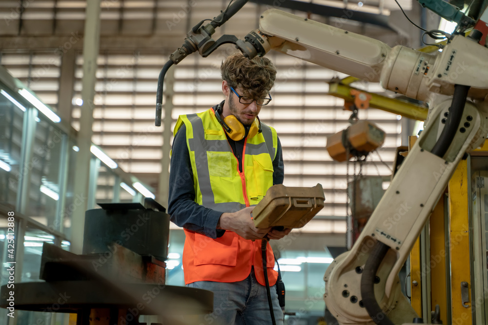 Fototapete engineer working and control robotic arm in manufacturing workshop,industry and engineering technolo