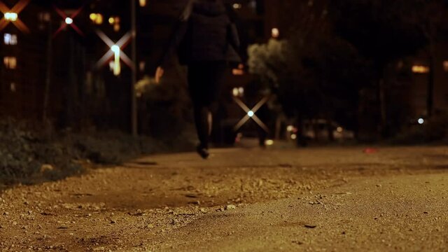 fear, danger - young man in the park at night runs away from his attacker