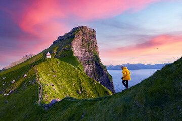 Kallur lighthouse on green hills of Kalsoy island