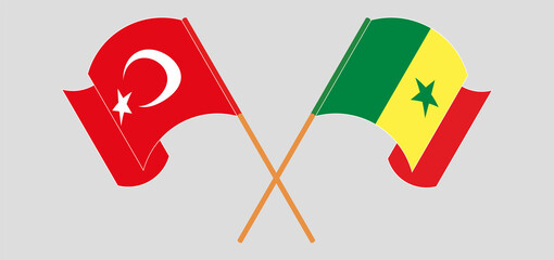 Crossed and waving flags of Turkey and Senegal