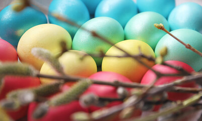Easter eggs and blossoming branches on a light background. close-up