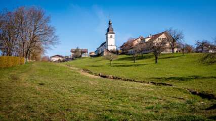 Idyllic landscape. Panoramic view of Switzerland Village with agriculture field, church and houses.