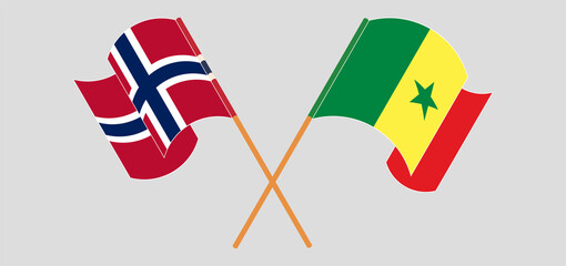 Crossed and waving flags of Norway and Senegal
