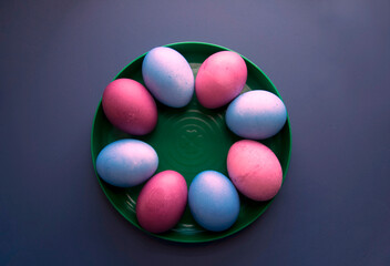 Easter colorful eggs on a plate. Top view