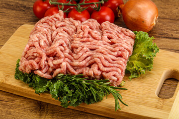 Raw pork minced meat over board