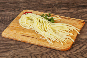 Chechil spaghetti cheese over board